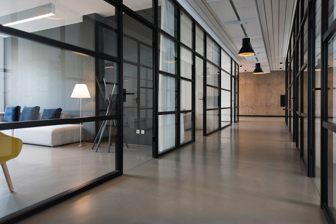 Bright office with shared work tables and greenery